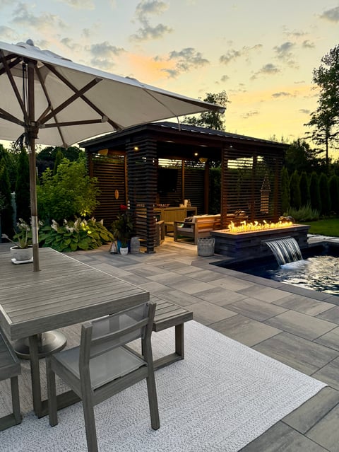Luxury outdoor living space with pool and fire pit